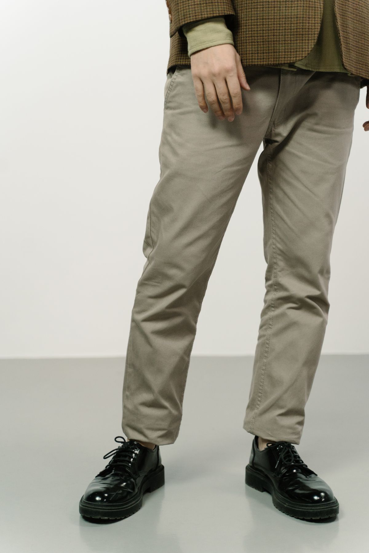 Tapered plus size chinos paired with a tweed blazer and chunky loafers