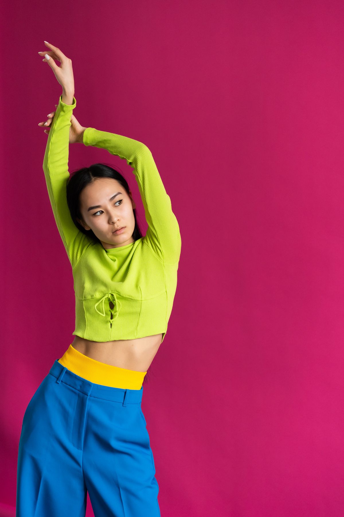 Plus size color block outfit pairing a lime top with vivid blue trousers